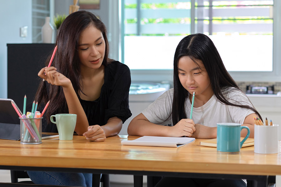 student and tutor together at a desk in Riverside